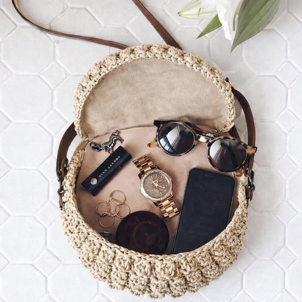 Handbag essentials women wish for inside a straw handbag